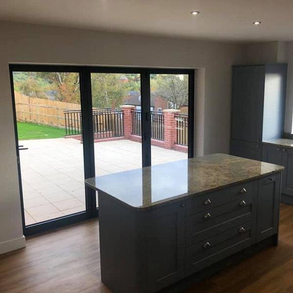 Kitchen island and Bi-folding doors leading to the patio