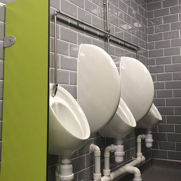 Mens urinals against a tiled wall